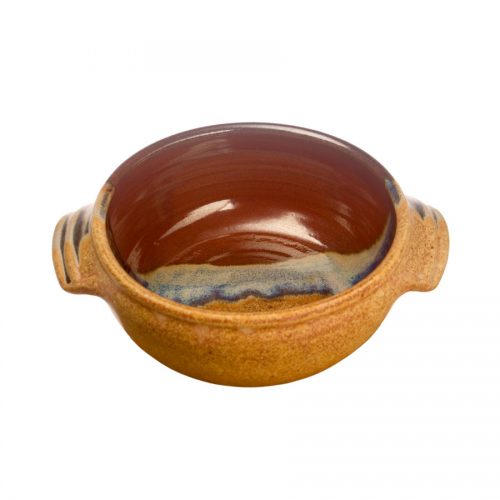 a small, handmade, red and orange soup bowl with straight sides, handles, and a variegated blue band across the surface.